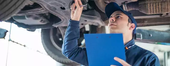 technician under car