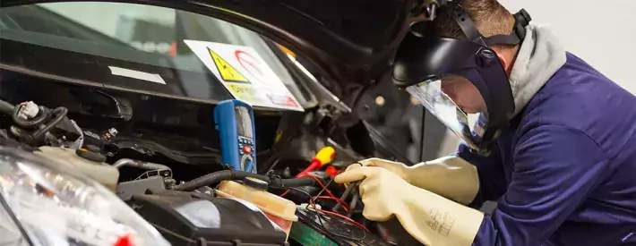 Technician under bonnet