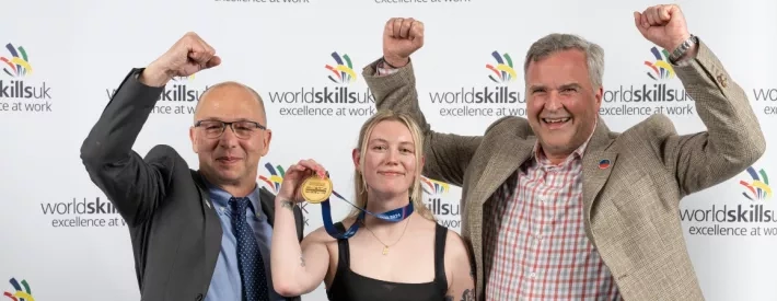 IMI Skills Competition winner holding gold medal